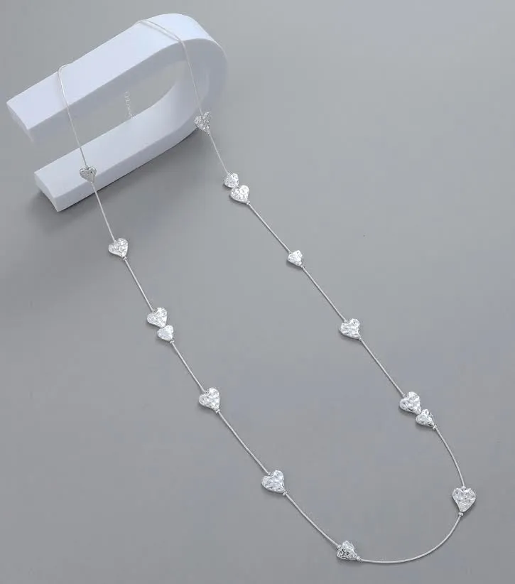 Long silver hammered hearts necklace